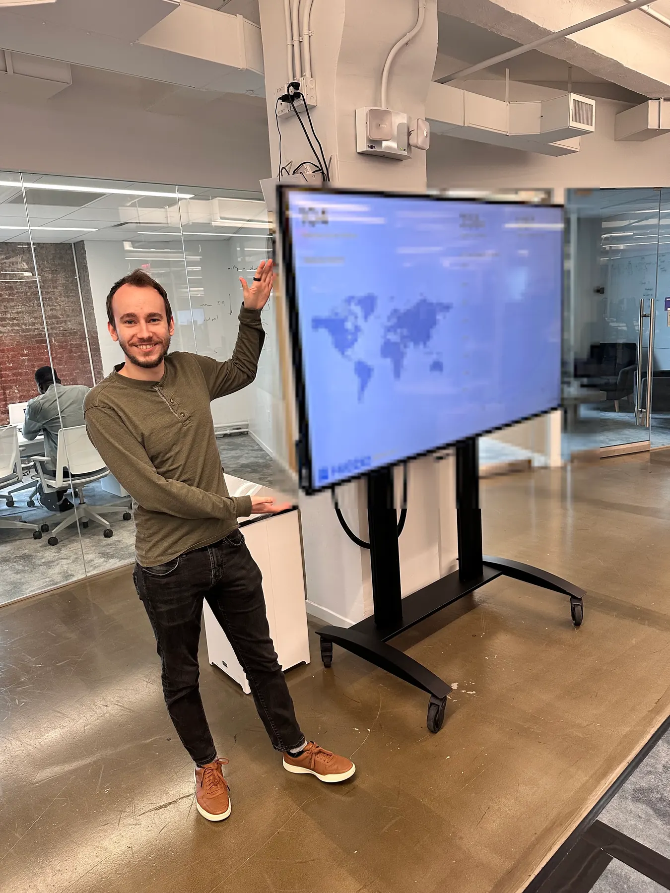 Customer standing beside a TV dashboard during an on-site visit.