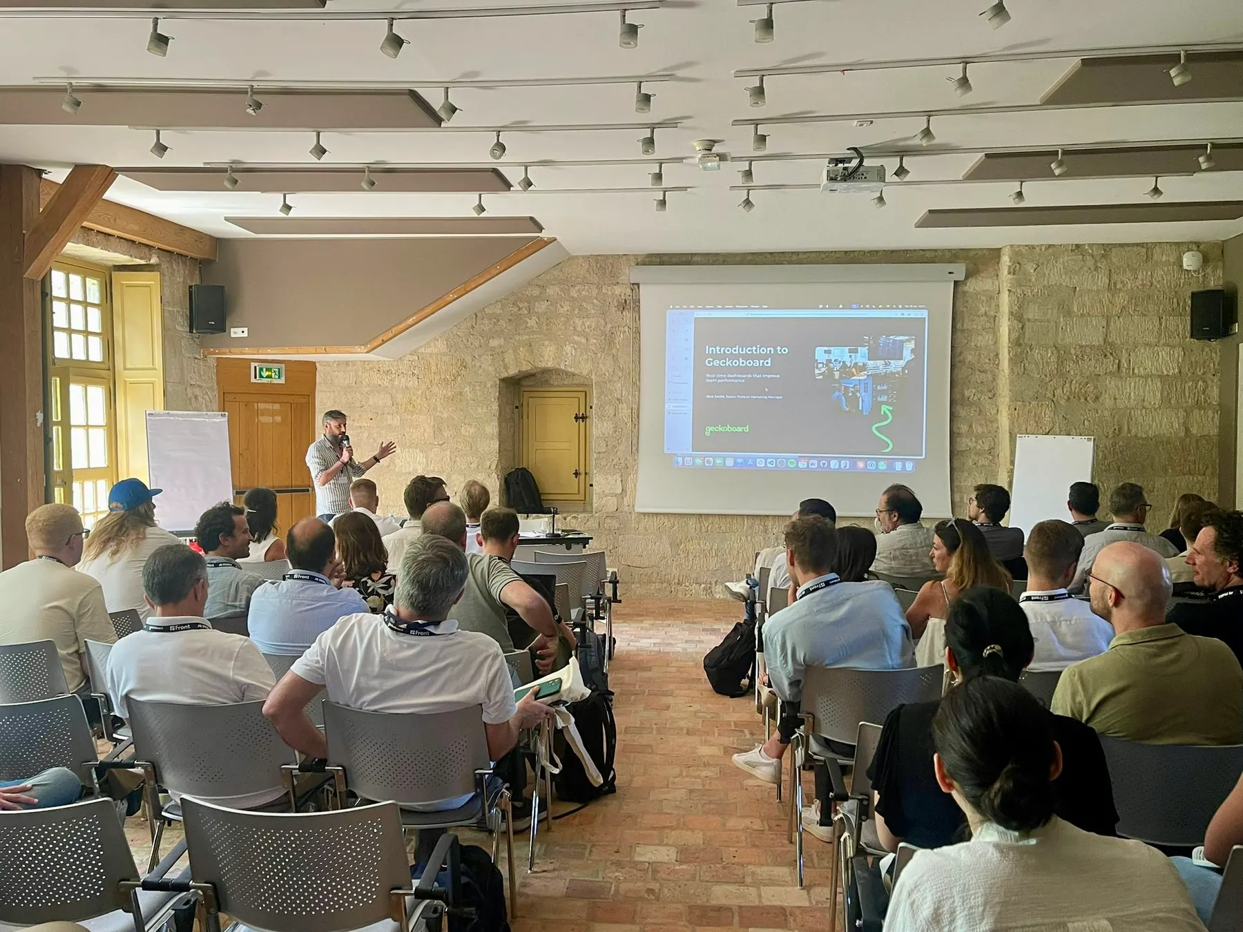 Nick Smith presenting Geckoboard to a room of Aircall partners at Aircall Ascend in Paris.