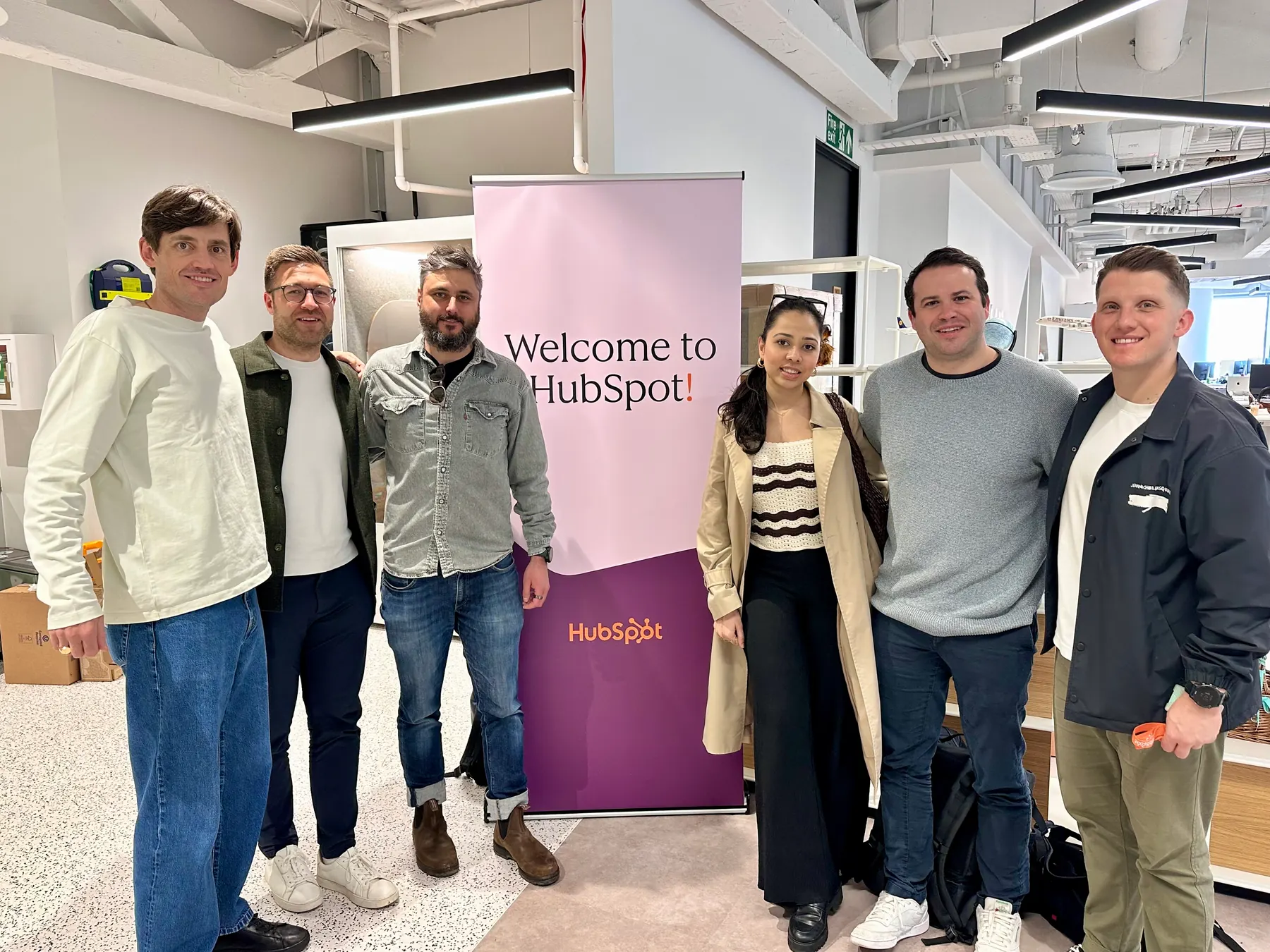 Group photo at HubSpot with a Welcome to HubSpot sign.